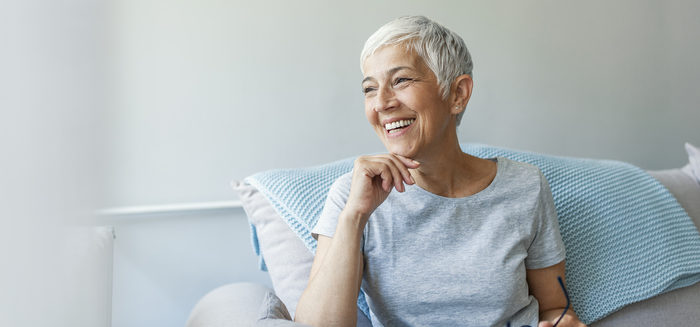 Happy mature woman relaxing by the window.